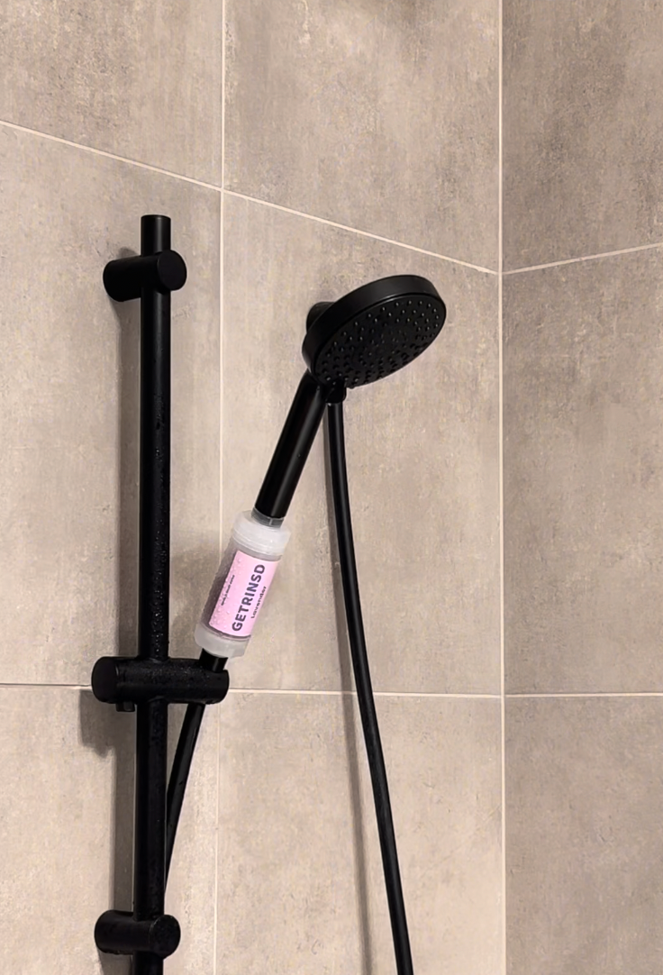 GETRINSD Vitamin C Aroma Shower Filter with lavender scent, showing filter cartridge and packaging in a bathroom setting.